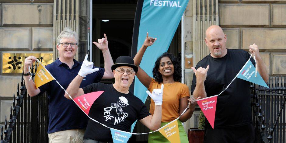 Philip Gerrard, Deaf Mimo, Nadia Nadarajah, and Gavin Lilley outside the Deaf Action's premises for the launch of Edinburgh Deaf Festival.